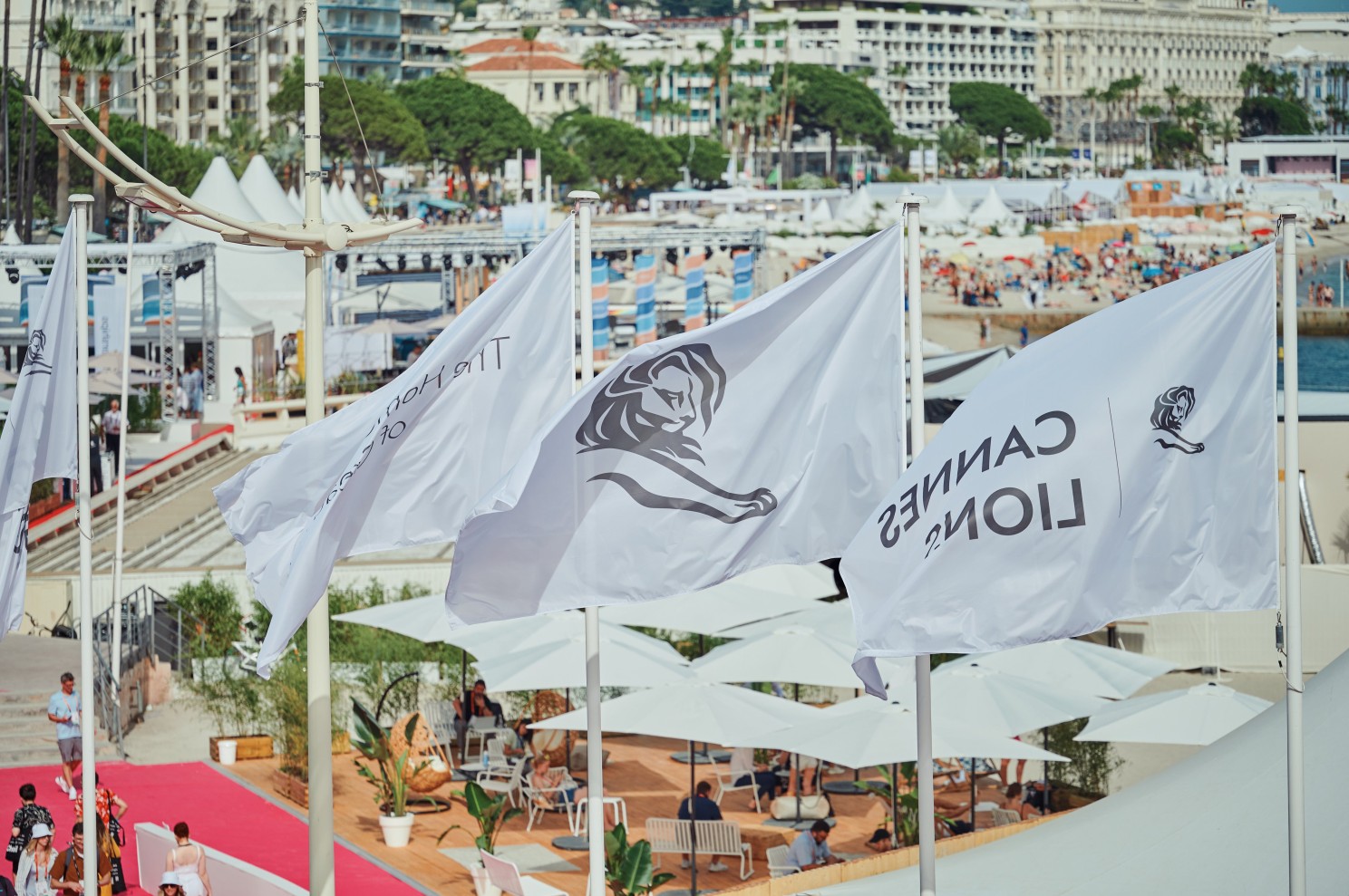 Cannes Lions flags flying at the Palais des Festivals, Cannes 2026. Upside Journal.